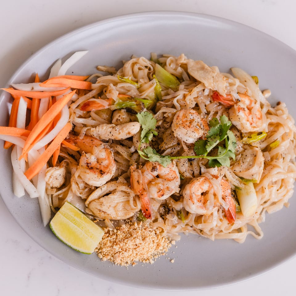 Lantern House Kitchen & Bar's shrimp and chicken pad see ew with lime, peanuts, and pickled vegetables.